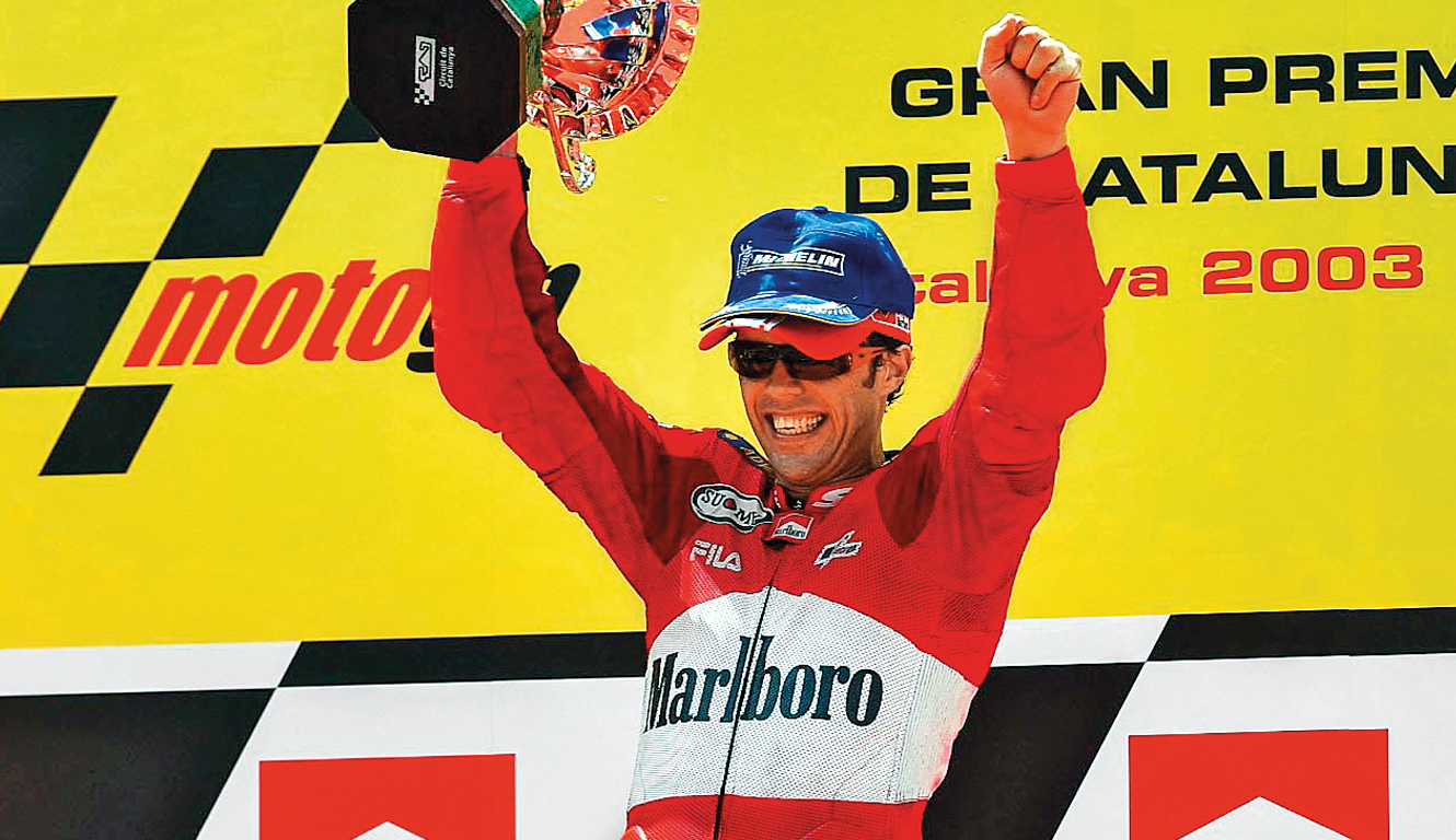 Loris Capirossi sul podio di Barcellona dopo la vittoria nel 2003